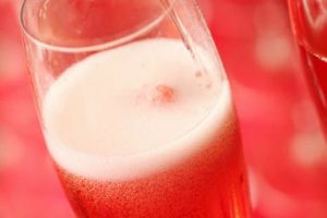 Glasses of rose Champagne sparkling wine with a strawberry